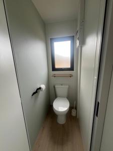a small bathroom with a toilet and a window at Camping Cristal d'Opale in Camiers +18 photos