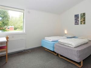 two beds in a room with a window at 20 person holiday home in Herning in Herning