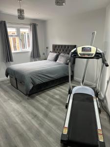 a bedroom with a bed and a treadmill at Private 2 bed Apartment - Edinburgh - Sleeps 2 Max in Edinburgh