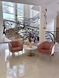 a lobby with two chairs and a spiral staircase at Leśne Ustronie in Lubiszewo