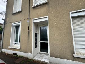 a door of a house with two windows at Le Nid du Guesclin in Thouars