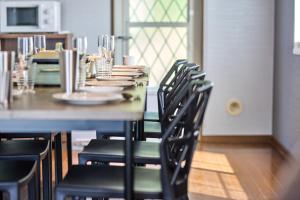 a dining room with a long table with chairs at TOCORO Mt Fuji Shizuku in Oishi