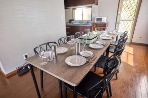 a long wooden table with chairs and plates on it at TOCORO Mt Fuji Shizuku in Oishi