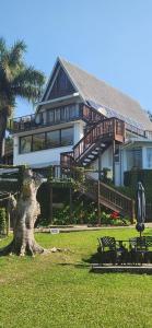 a large house with a tree stump in front of it at Thiseldoo Holiday Home in Scottburgh
