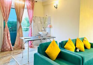 a living room with a blue couch and yellow pillows at Evara Luxury Living Central 3BHK near HITEC City in Hyderabad