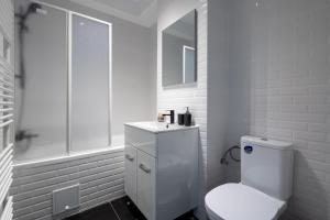 a white bathroom with a toilet and a shower at Plaza Residence Studio 197 in Bucharest +24 photos