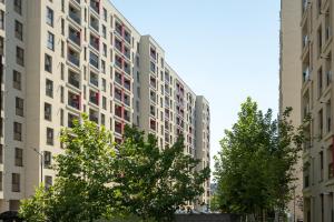 two tall buildings with trees in front of them at Plaza Residence Studio 197 in Bucharest