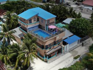 an aerial view of a house with a swimming pool at Breeze Haven Surf Retreat in Thimarafushi