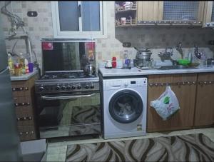 a kitchen with a stove and a washing machine at Cairo , New Nozha in Cairo