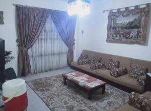 a living room with a couch and a coffee table at Cairo , New Nozha in Cairo