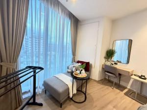 a hotel room with a bed and a desk and a window at Edge central Pattaya by kansiree in Pattaya