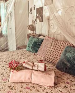 a bed with a bunch of pillows on it at Locanda San Tomaso in Treviso