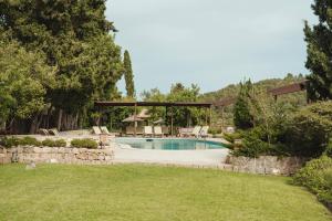 a swimming pool in a yard with a gazebo at Rondaia, a Winery & Fincahotel-Agroturismo in Tramuntana in Valldemossa