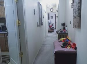 a hallway of a house with a room with a table and a hallway at Cairo , New Nozha in Cairo +1 photo
