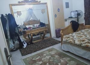 a bedroom with a mirror and a bed and a table at Cairo , New Nozha in Cairo