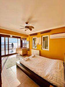 a bedroom with a bed and a view of the ocean at Ayvalik Seafront Villa Mansion Summer House in Ayvalik in Ayvalık