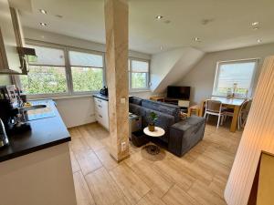 a living room with a couch and a table at ZK Living Ferienwohnung OG in Kleinkötz