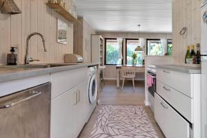 a kitchen with a sink and a dishwasher at 13381-1-Hojby-Kongsbovej-33 in Højby +19 photos