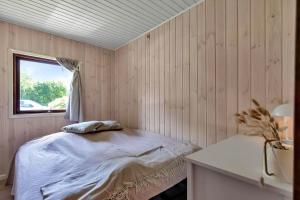 a bedroom with a bed and a window at 13381-1-Hojby-Kongsbovej-33 in Højby