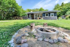a home with a fire pit in the yard at 13381-1-Hojby-Kongsbovej-33 in Højby