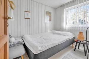 a small bedroom with a bed and a window at 11108-1-Nykobing-Sj-Osterlyngvej-131 in Nykøbing Sjælland