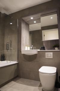 a bathroom with a toilet and a sink and a mirror at Cozy 1 bedroom flat in city centre in Birmingham +31 photos