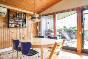a dining room with a wooden table and chairs at 13371-1-Vig-Tjornedalen-3 in Vig