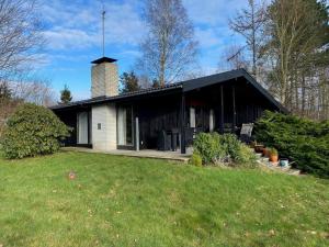 a house with a black roof and a grass yard at 13371-1-Vig-Tjornedalen-3 in Vig