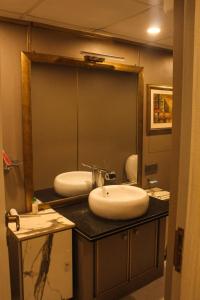 a bathroom with two sinks and a large mirror at Airport Hotel in Karachi +9 photos