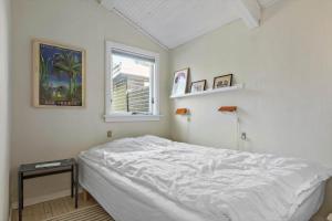a bedroom with a white bed and a window at 11120-1-Nykobing-Sj-Birkehaekken-9 in Nykøbing Sjælland