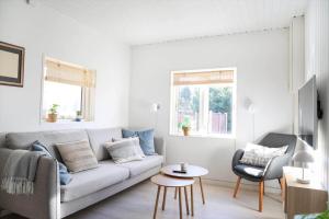 a living room with a couch and a chair at 12258-1-Sjaellands-Odde-Fasanvang-11 in Tjørneholm