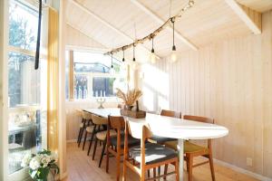 a dining room with a white table and chairs at 13393-1-Vig-Lyngtoftevej-9-D in Vig