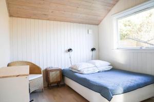 a small bedroom with a bed and a window at 13393-1-Vig-Lyngtoftevej-9-D in Vig