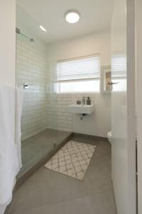 a bathroom with a shower and a sink and a toilet at Chic apartment with a beautiful view in Cape Town +12 photos