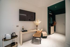 a room with a table and a chair and a door at Duse Luxury Stay in Milan