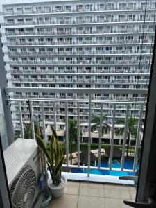 a view of a large building from a window at MOA Staycation Condotel PASAY in Manila +4 photos