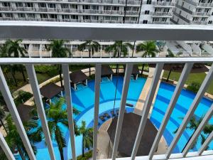 a view of a swimming pool from a balcony at MOA Staycation Condotel PASAY in Manila
