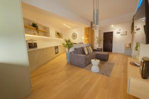 a living room with a couch and a kitchen at Nova ONE Harmony in Bacău