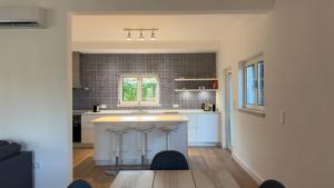 a kitchen with a counter and stools at Bela Vista - Countryside home in Gradil