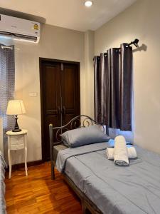 a bedroom with two beds and a window at 103-25 Kathu Waterfall in Phuket