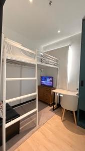 a bedroom with bunk beds and a desk and a computer at SS Homestay by Stella in Kota Kinabalu