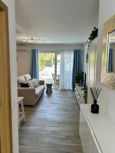 a living room with a couch and a table at Casa Pura Vida in Tarajalejo