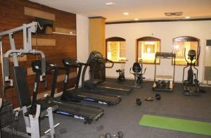 a gym with several treadmills and other equipment at Airport Hotel in Karachi