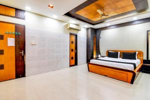 a bedroom with a bed and a door in it at Hotel O The Luxury Palace in Bhubaneshwar