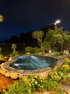 a swimming pool in a garden at night at An House in Sóc Sơn +27 photos