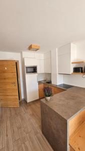 a kitchen with white cabinets and a counter top at Panorama Dolomiti in San Vigilio Di Marebbe