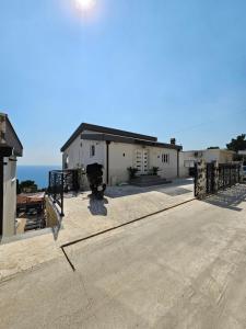 a building with a large patio with the ocean in the background at Vila Eden in Bar