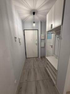 a room with a hallway with a door and wooden floors at RESORTLuxurySPA in Wrocław