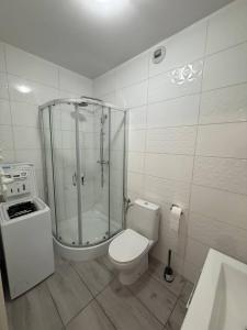 a bathroom with a glass shower and a toilet at RESORTLuxurySPA in Wrocław +23 photos