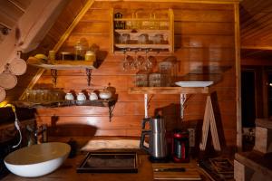 a kitchen with wooden walls and a counter with a sink at Cuneli bungalov in Çamlıhemşin